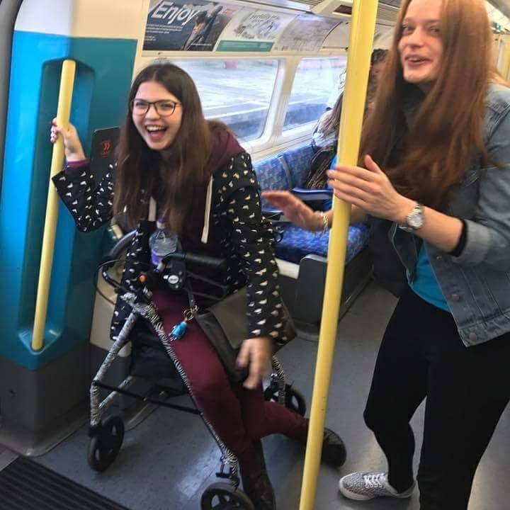 Jenni laughing while riding on public transport.