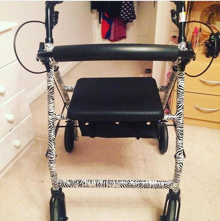 A close up view of a rollator with a zebra print frame.