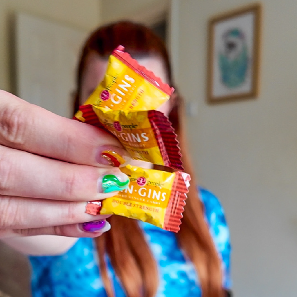 Jenni holding gin gins up close to the camera