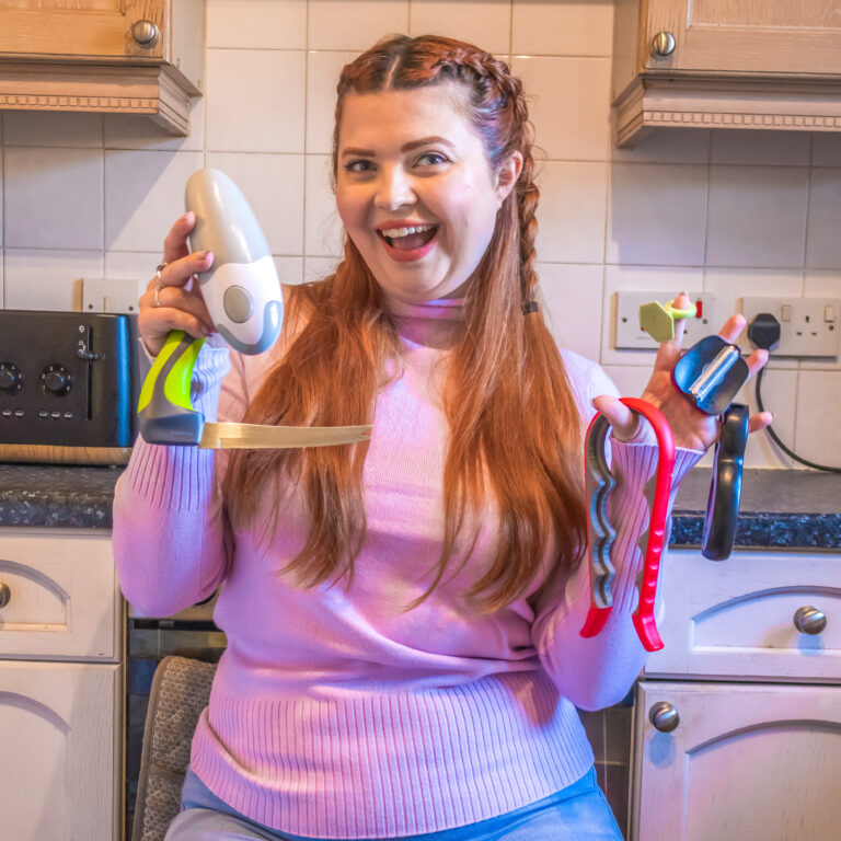 Jenni sat in the kitchen with various kitchen hacks and gadgets