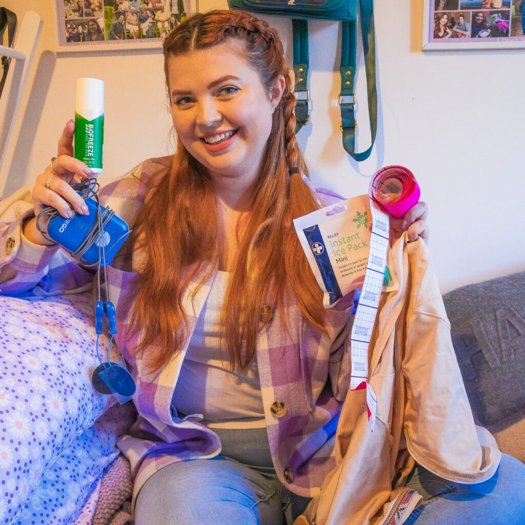 Jenni sat on her bed with various pain tools