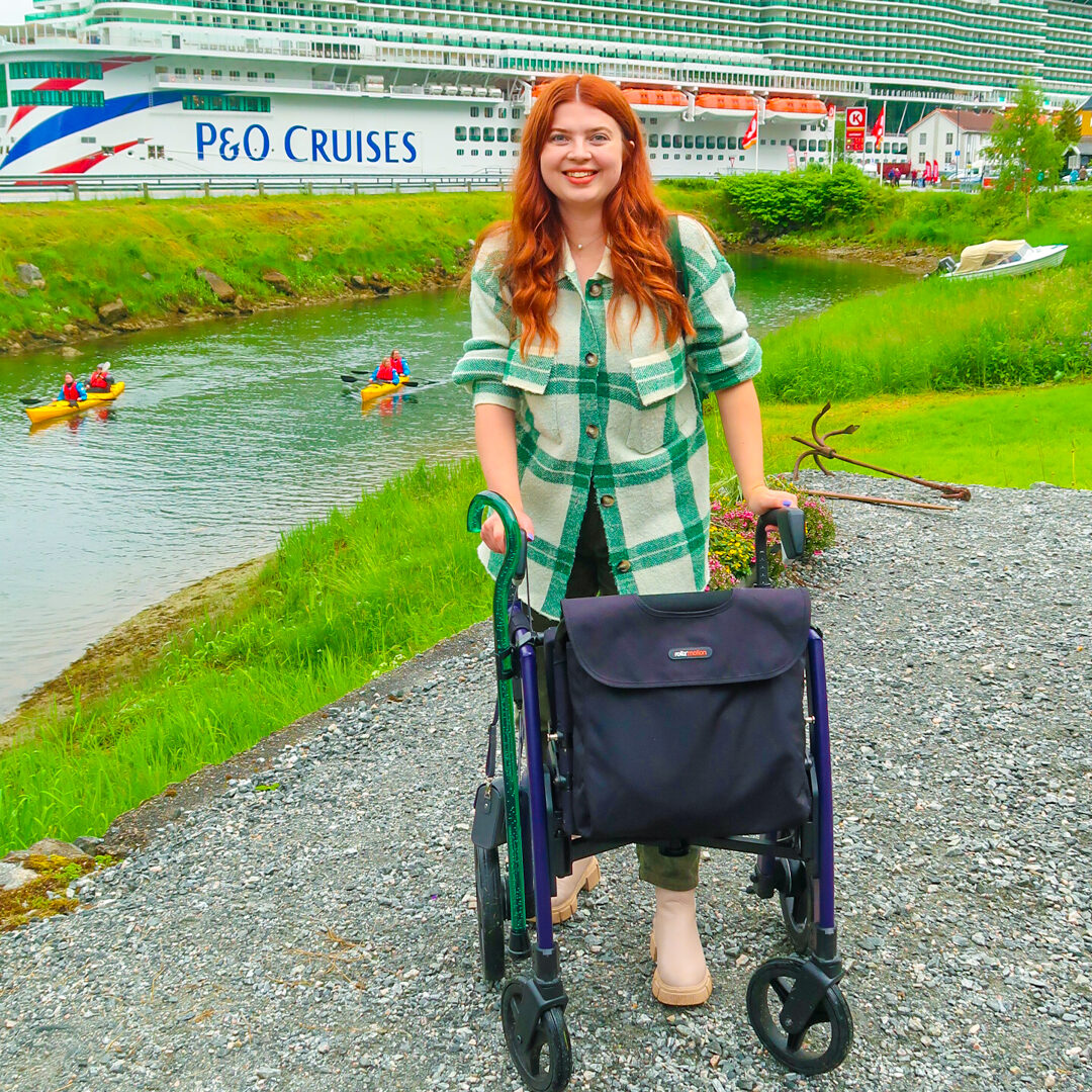Jenni walking with her Rollz Motion rollator. A P&O Cruiseline is in the background.