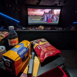 a pov photo at the cinema ready to watch downton abbey with snacks