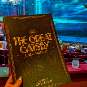 a photo of the stage at the london coliseum theatre Jenni is holding a programme for the great gatsby out in front of her