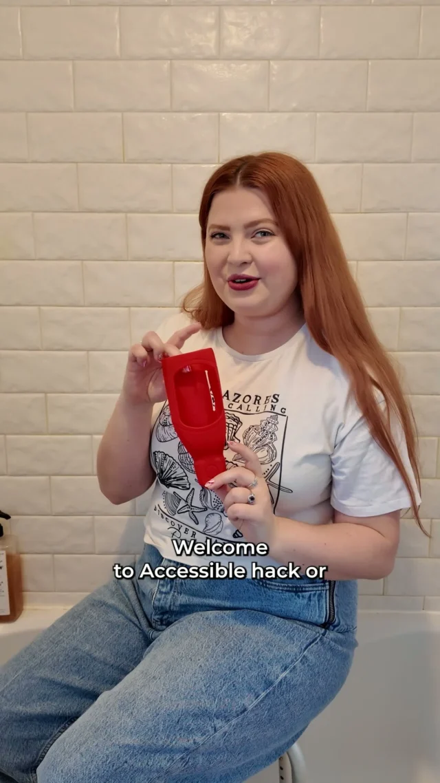 Welcome to Accessible Hack or Send It Back, the series where I try supposedly accessible gadgets so you don’t have to.
Today we’re testing a little gadget that’s meant to make it easier to get shampoo, conditioner and soap out of bottles. It attaches to the wall, you take the lid off your favourite toiletries and place it upside down in the gadget. You then squeeze the dispenser to get the product out making it easier than using the bottle directly and meaning you use every drop of your product.

First, I tried it with a bottle that looks like it’s made for this gadget. You may need a non disabled person to help you get the lids off the bottles and get the bottle into the dispenser. I applied the adhesive sticker to my tiles and mounted the gadget. The first product I was using was conditioner and it didn’t come out very well. I assumed that was because the product was too thick so I tried something else.

I thought shampoo would be a better option but this time the bottle was a more unusual shape but it still worked well at fitting into the gadget.

The product still wasn’t coming out so we then did a bit of DIY and made the hole slightly bigger… and that made a big difference. After that, it worked perfectly and dispensed the product much more easily.

However, when I came back into the bathroom later, it had fallen off the wall. My tiles don’t hold adhesive very well, so that could be part of the issue.

So what do you think? Is this an Accessible Hack or would you Send It Back? Let me know in the comments.

For me, it’s a send back. But with a little alteration to make the opening bigger, and somewhere better to stick it I think this could work really, really well.

#LifeHacks #DisabilityHacks #AdaptiveProducts